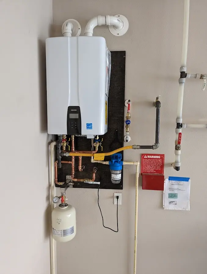 Professional plumber installing copper piping in a Bushnell home